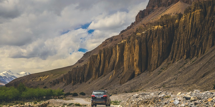 The beautiful snapshot of a road passing through the barren hills into the horizon