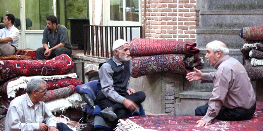 People at a carpet market