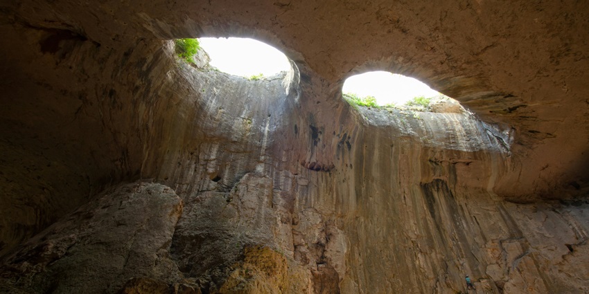 People exploring difficult caves