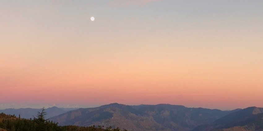 A quaint view of Chail captured against the backdrop of vibrant hues and settling sun.