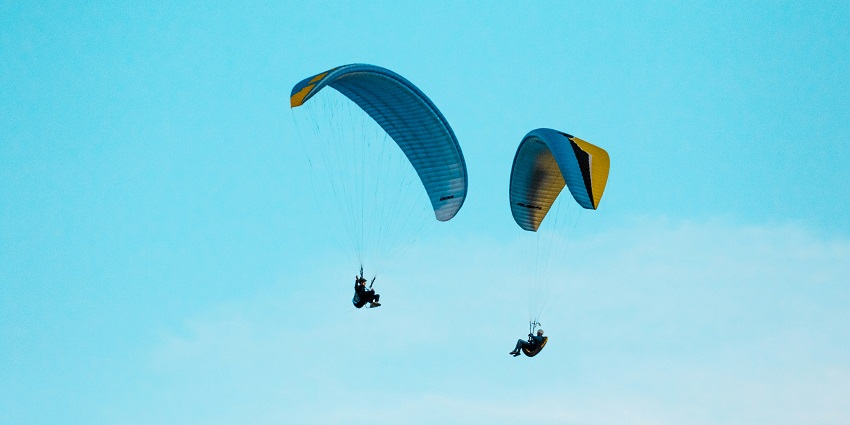 Paragliders up in the air in Chakung Durpiney, a quaint spot for paragliding in Sikkim.