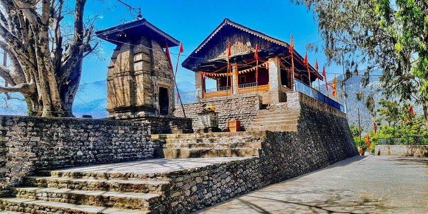 A serene glimpse of Chamunda Devi Temple, nestled atop a hill in Himachal Pradesh.