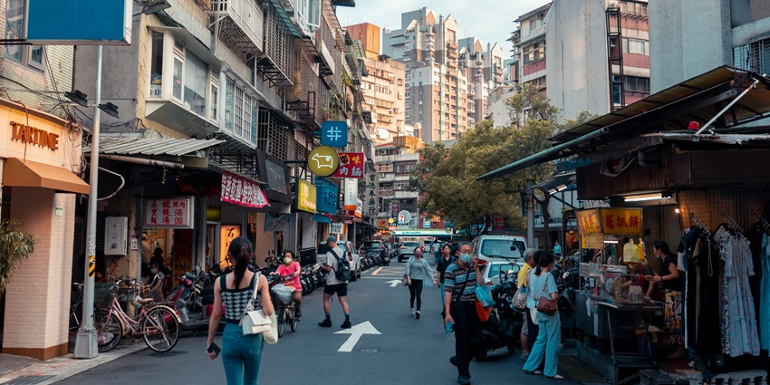 People roaming on a street market and enjoying street food at evening