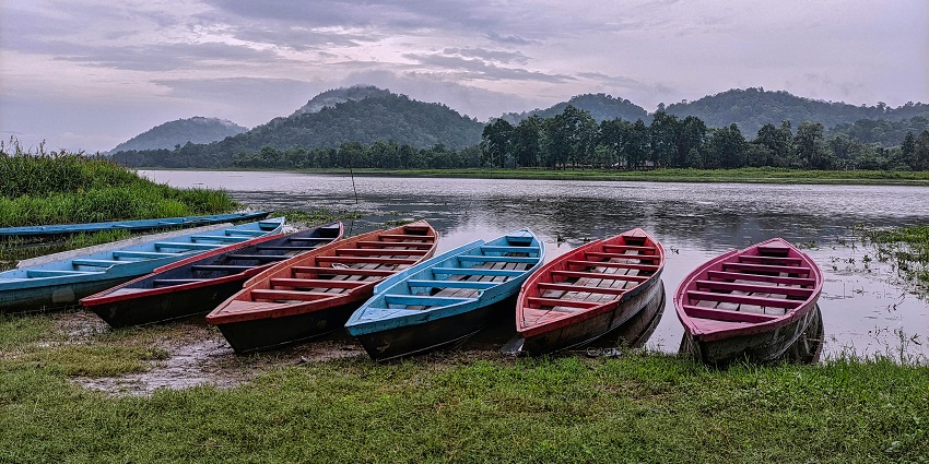 Colourful boats spotted at the lush green banks of the scenic Chandubi Lake, Assam.