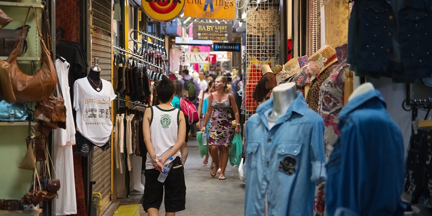 Vibrant scene at Chatuchak weekend market, bustling with shoppers and colourful stalls.