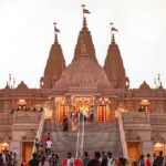 Panoramic image of a beautiful hindu temple and devotees outside the vicinity