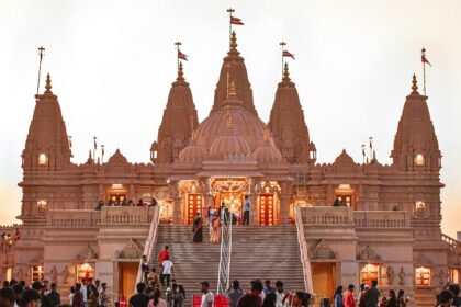 Panoramic image of a beautiful hindu temple and devotees outside the vicinity