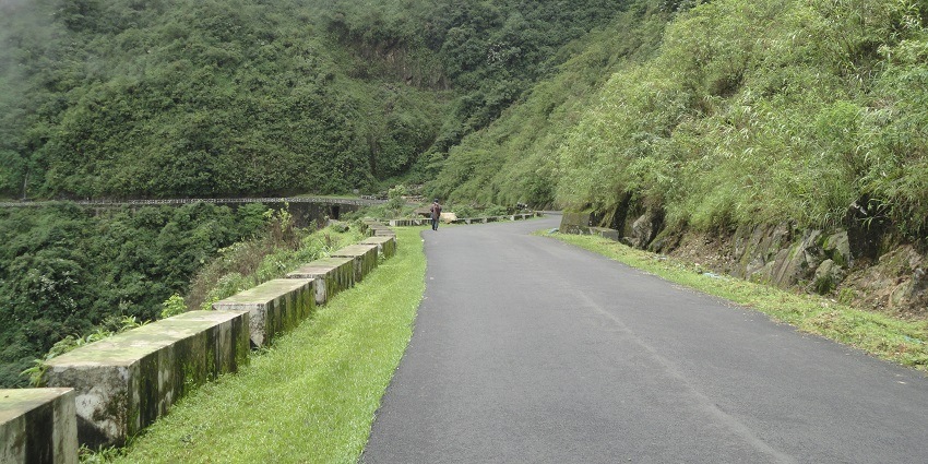 A road to cherrapunji, Meghalaya surrounded by greenery and misty weather with twisty road.