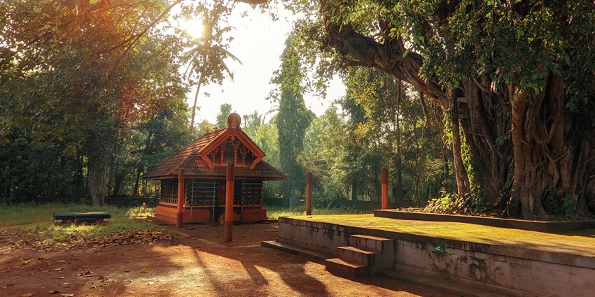 Elegant temple dedicated to Goddess Annapoorneswary, featuring Kerala architecture and serene lakeside surroundings.