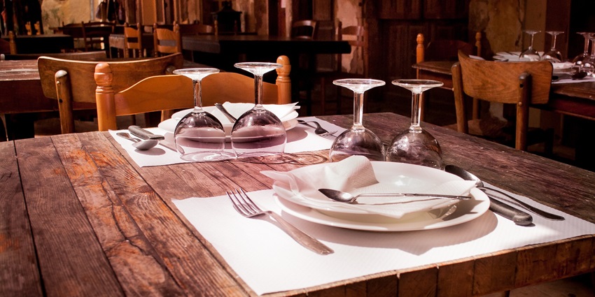 A picture of a table at a Chinese restaurant with cutlery placed on top