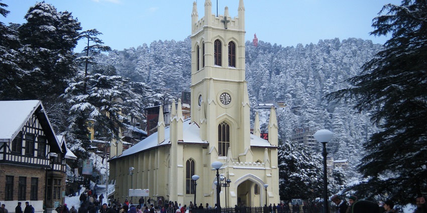 A picture of a church in Shimla taken from a distance showing people walking