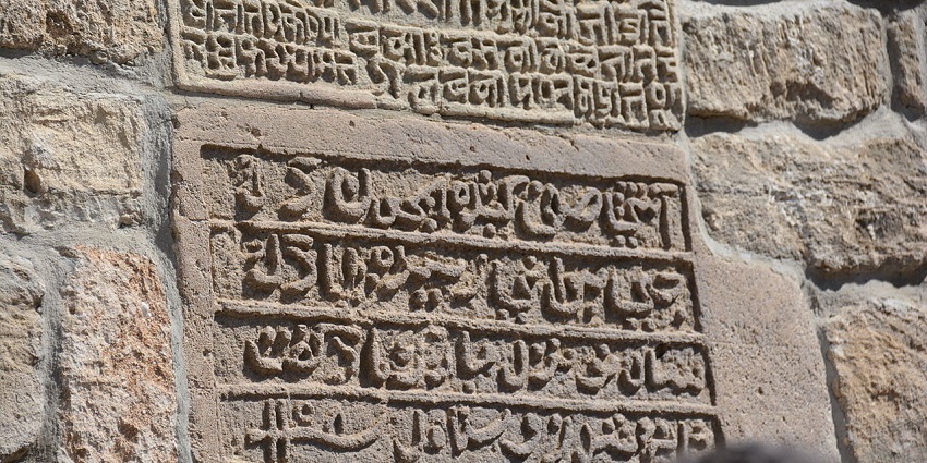 Old silver coins of Manikya Dynasty that have figures and words engraved on them.