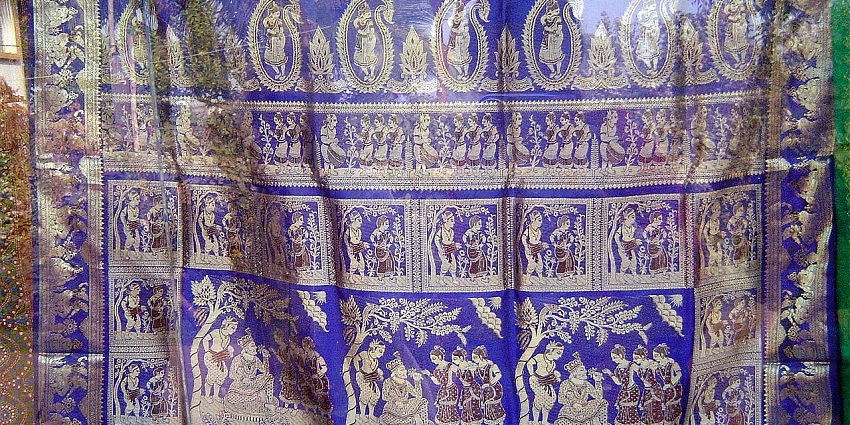 A view of a Baluchari blue-coloured saree with golden embroidery in the daytime.