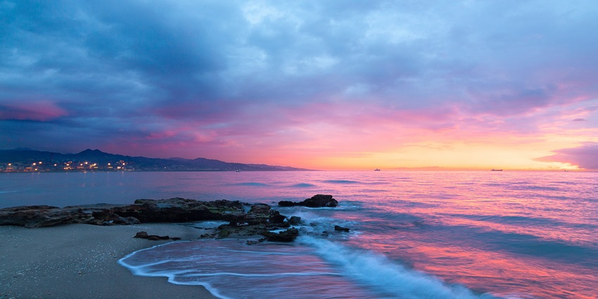 The sun settling down and casting red hues on the blue skies at the serene Con Dao.