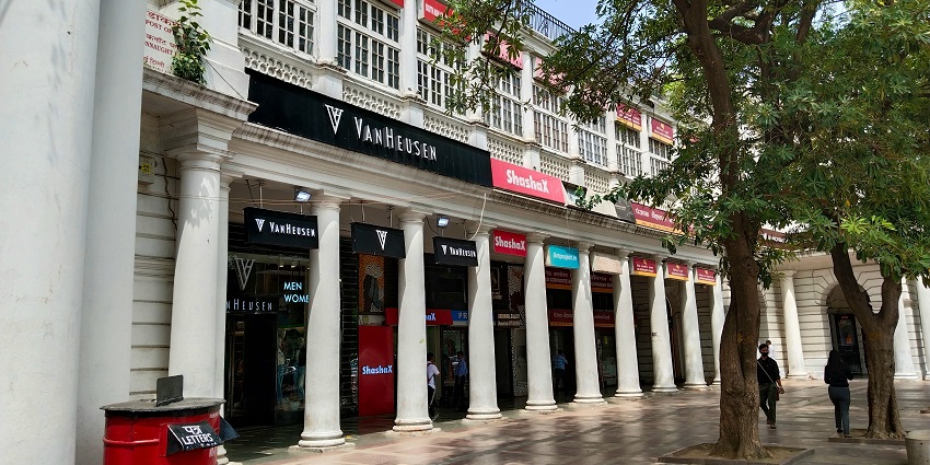 A breathtaking view of a concrete white building in Connaught Place during the daytime.