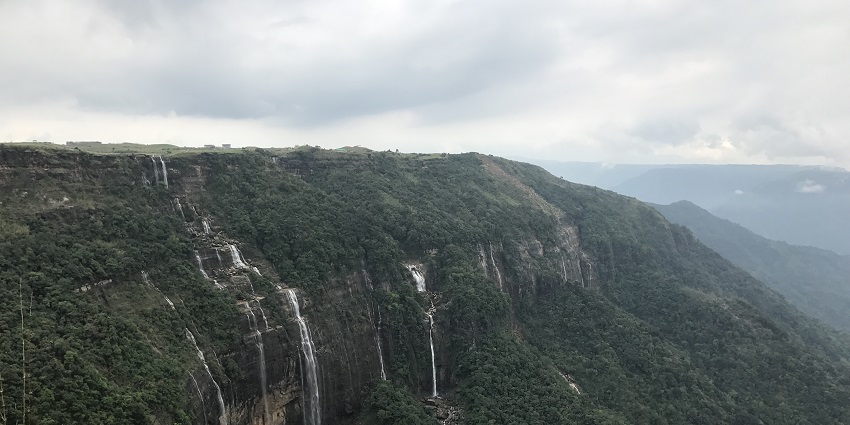 A breathtaking view of a waterfall surrounded by lush greenery during the daytime.