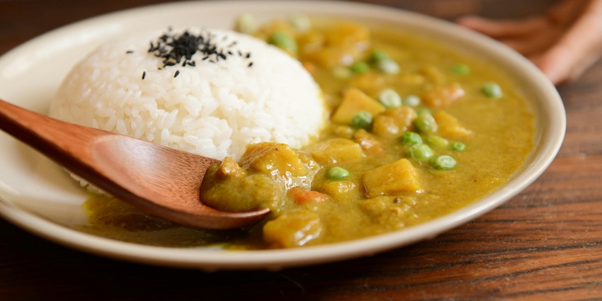 Curry and rice dish featuring aromatic, spiced curry served alongside steamed rice.