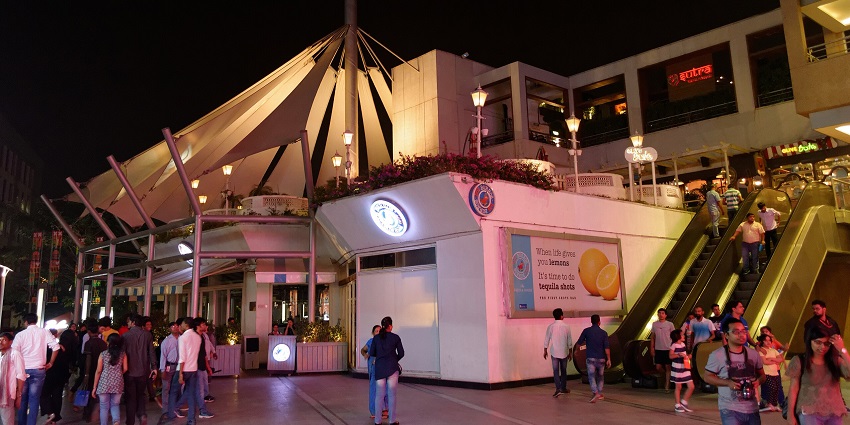 Night view of DLF Cyber Hub, Gurgaon with vibrant lights and people strolling around the DLF Cyber Hub