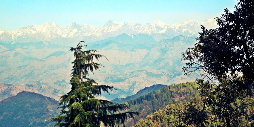 Beautiful view of Dalhousie with green hills, colonial buildings, and misty surroundings.