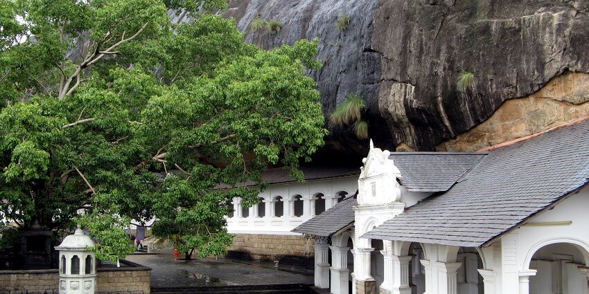 A picture of Dambulla Cave Temple, a tourist spot, with beautiful white architecture.
