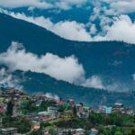 A bird’s eye view of the lush greenery and terraced fields dotted with colourful houses.