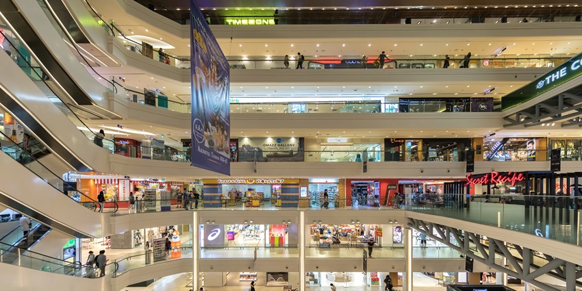 A picture of the interior of a shopping mall in Darjeeling with multiple brand stores open all around