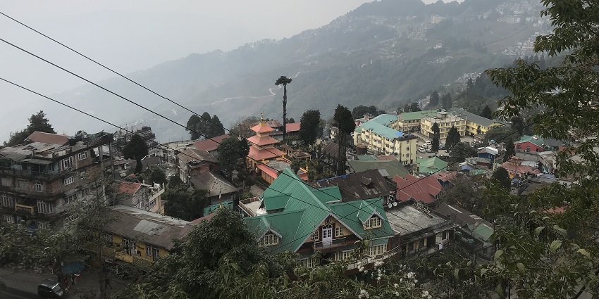 An aerial view of a locality on a hill during cloudy weather