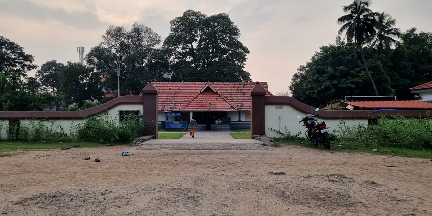 The entry gate of a temple with the temple premises in the background