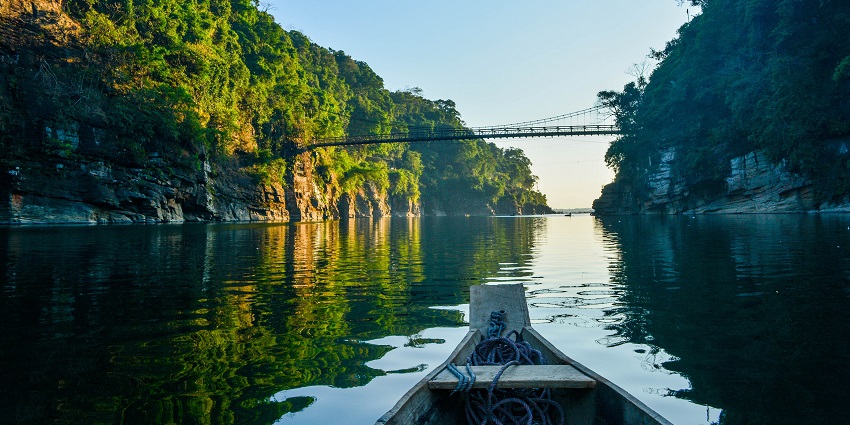 A captivating view of the popular Dawki River in Meghalaya with a bridge over it.