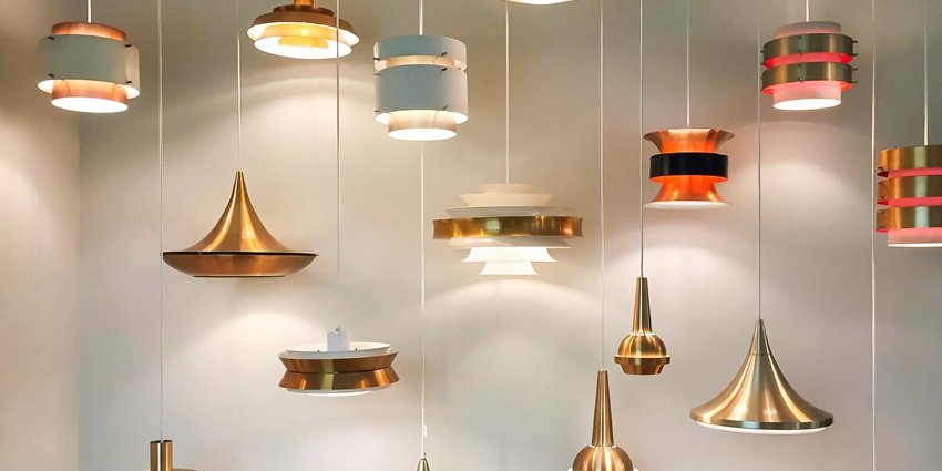 Elegant gold and red pendant lamps hang in a modern interior, casting soft warmth around