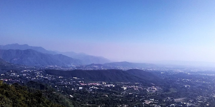 A picture of the lower city taken from a hilltop in Dehradoon along with green hills