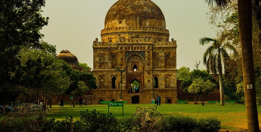 A breathtaking view of a historical monument in Delhi surrounded by lush greenery.