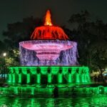 A breathtaking view of Delhi during the evening with a fountain with colourful lights.