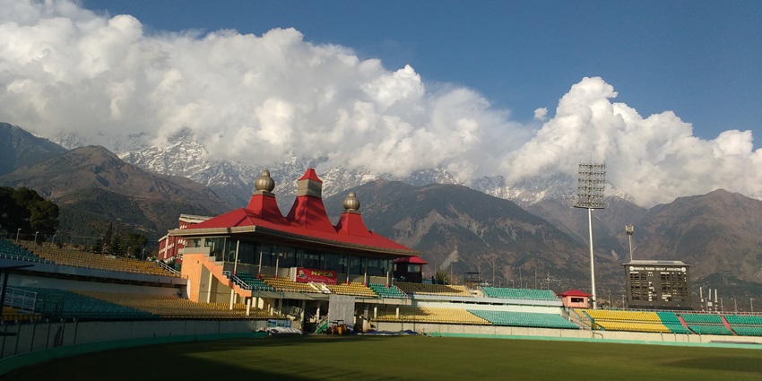 A picture of the pavilion of Dharamshala Cricket Stadium with stunning views of the Himalayas in background