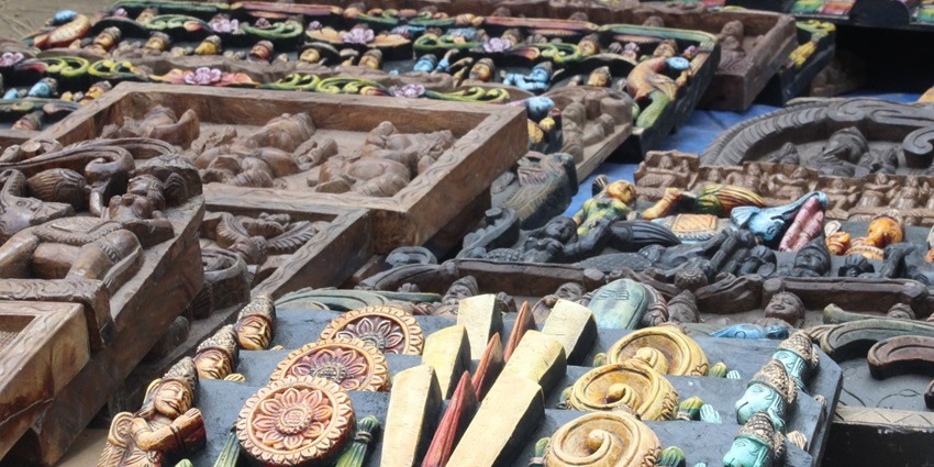 Image of handicraft items displayed in Dilii Haat's shop, INA - showcasing traditional significance