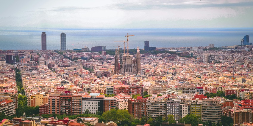 An aerial picture of a city with multiple houses and greenery spread