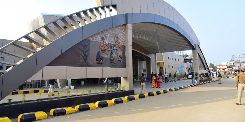 Dimapur Railway Station with its modern design and busy platform surrounded by greenery.