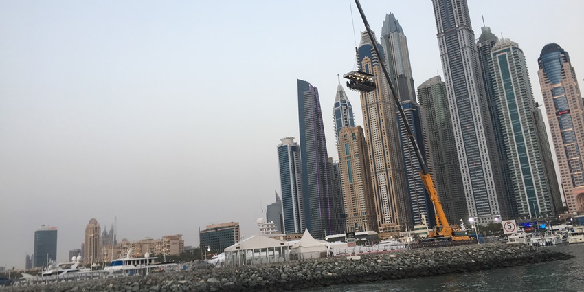 A picture of skyscrapers in Dubai taken from a cruise, also showing an elevated dining platform