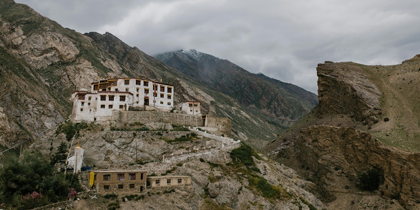 A hilly terrain with houses during overcast weather