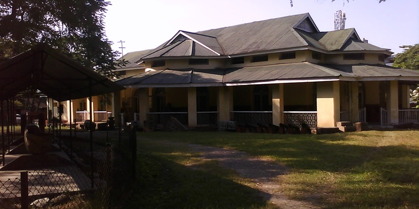 A picture of a building in Karbi Anglong region surrounded by a huge garden area from all sides