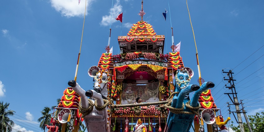 A picture of a majestic chariot at a festival in West Bengal with statues of deities