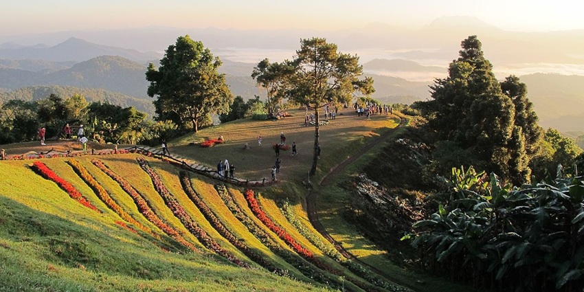 A verdant hill station view point with sweeping views of the distant mountain peaks