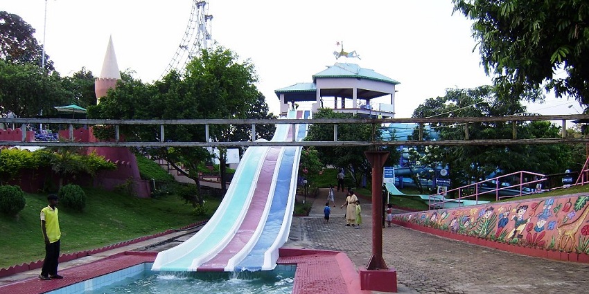 A picture of a water slide at a water park ending in a swimming pool