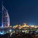 A picture of Dubai's beautiful skyline during nighttime with lights blinking from buildings