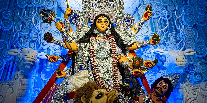 Statue of the Maa Durga with multiple arms, adorned with intricate jewellery.