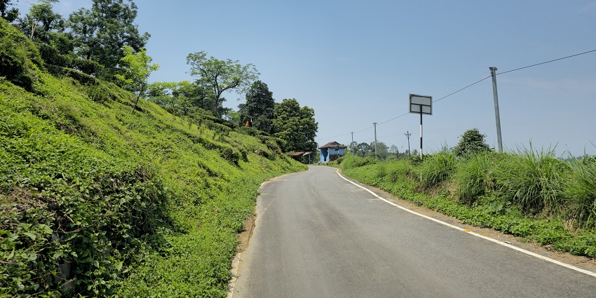 A road with hilly terrains on both sides