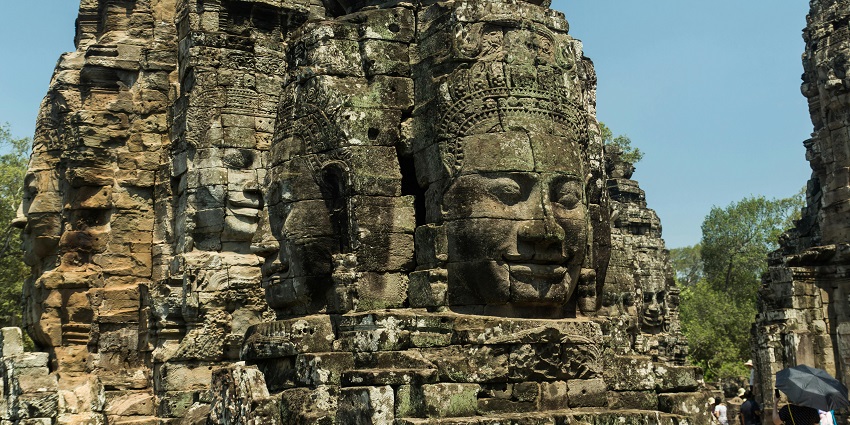 Explore the smiling faces and unique designs at the famous Bayon Temple in Cambodia