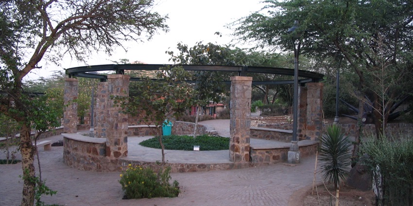A picture of a concrete platform in the middle of a park