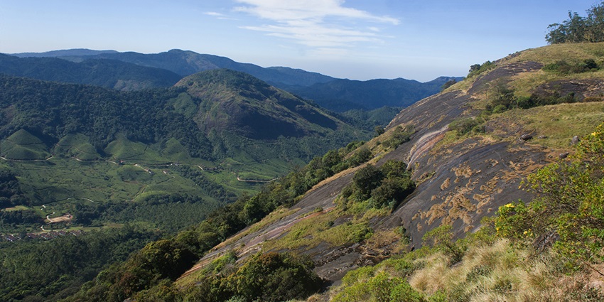 Rajamalai landscape in Eravikulam National Park with green hills and cloudy sky