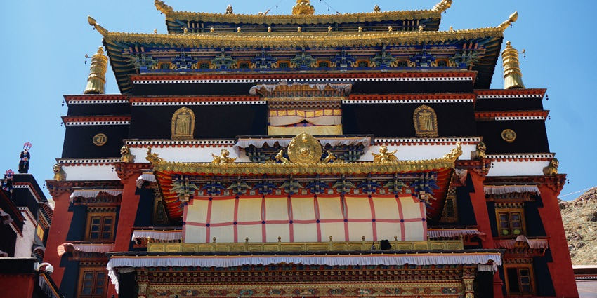 A frontal view of a Tibetan Monastery in Manali with traditionally built architecture and ambience
